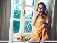 Nice teen Nasita undresses on her bed for nude poses on a window sill