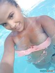 Young looking Latina girl Olivia hides her huge tits while taking selfies