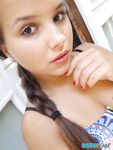Young looking Latina girl Olivia hides her huge tits while taking selfies