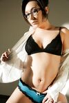 Solo model Sinn Sage leaves her glasses on while stripping naked