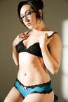 Solo model Sinn Sage leaves her glasses on while stripping naked