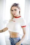 Hot blonde Jessa Rhodes takes of blue jeans to pose nude in red sneakers