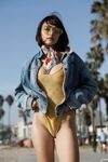 Adorable teen Basil Navas poses on the beach in yellow see-through bodysuit