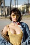 Adorable teen Basil Navas poses on the beach in yellow see-through bodysuit