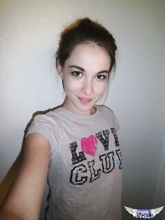 Cute brunette Emily undressing to take self shots of her bare tits and hot ass