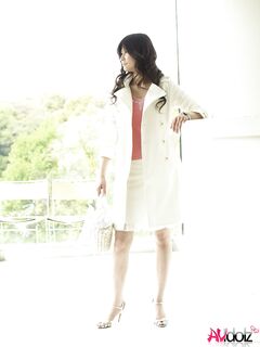 Clothed Japanese model Yuka Yamada shows her bare legs in a skirt