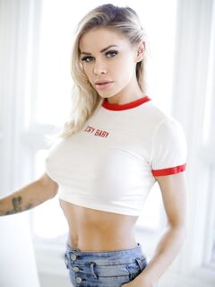 Hot blonde Jessa Rhodes takes of blue jeans to pose nude in red sneakers